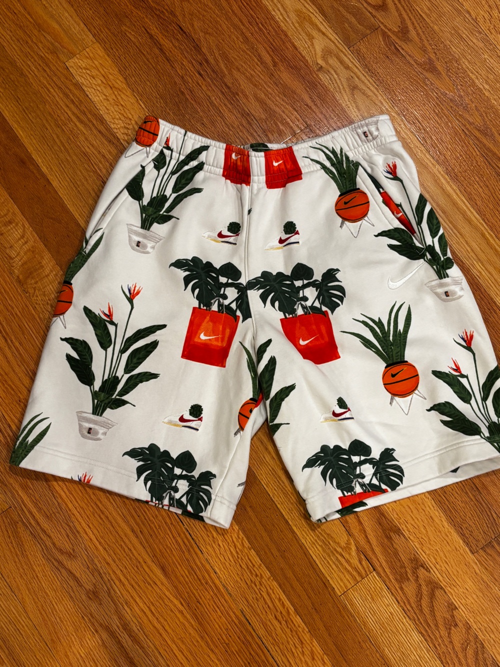 Nike White Athletic Shorts with Green Leaf & Orange Pot Print